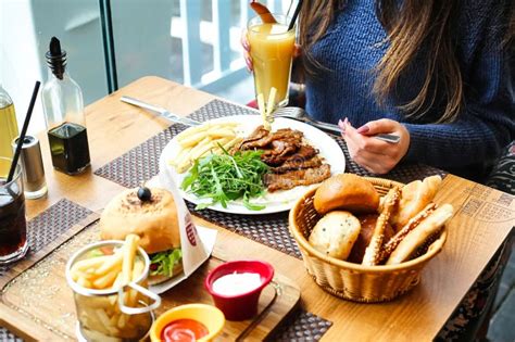 Woman Sitting At Table With Plate Of Food Stock Image Image Of