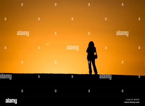 Silhouette Of Woman Watching The Sunset Hi Res Stock Photography And