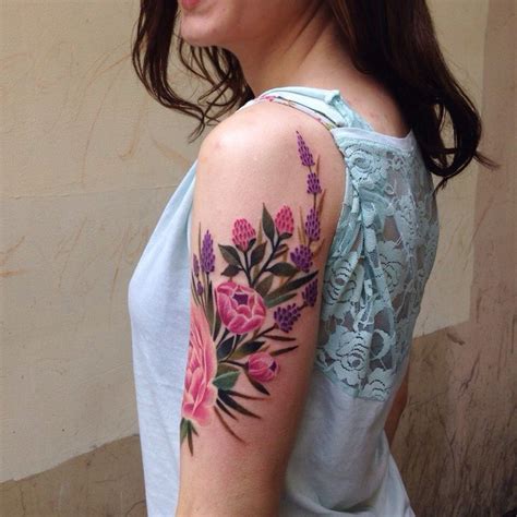 A Woman With A Flower Tattoo On Her Arm