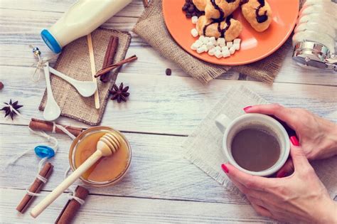 Premium Photo Female Hands Hold A Cup Of Coffee