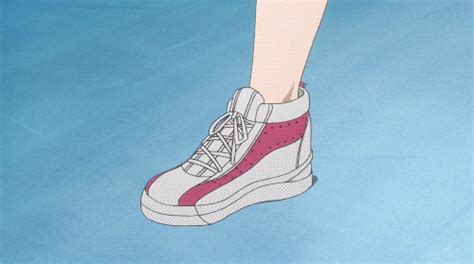 A Persons Feet With Pink And White Sneakers On Top Of Blue Water In