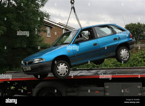 Car lifted by crane onto Scrap Dealers Lorry Stock Photo - Alamy