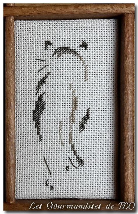 A Close Up Of A Cross Stitch Pattern In A Wooden Frame