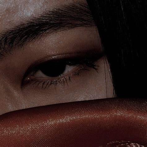 A Close Up Of A Person S Eye With Dark Hair