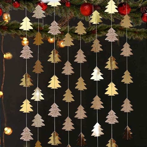 a christmas tree mobile hanging from the ceiling next to a christmas ...