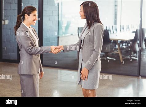 Standing Leadership Smiling Greeting Shaking Hands Hi Res Stock