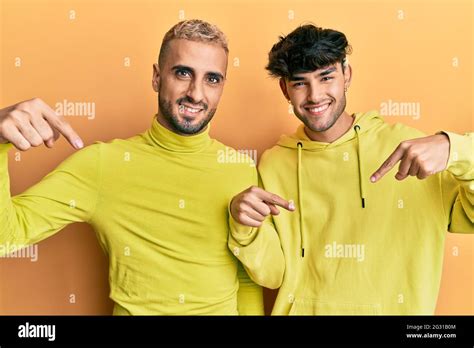 Homosexual Gay Couple Standing Together Wearing Yellow Clothes Looking