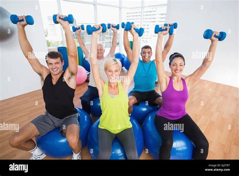 People lifting weights in gym class Stock Photo - Alamy