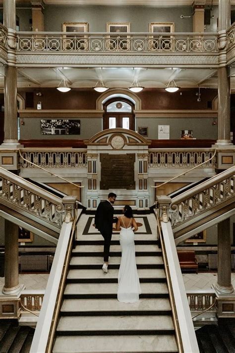 the bride and groom are walking down the stairs