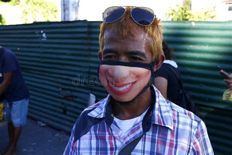 Filipino Man Use a Face Mask with a Funny Face Printed on it during the ...