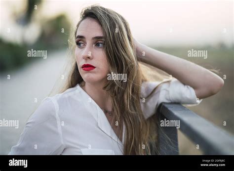 Portrait Of A Spanish Woman With Long Highlighted Hair Leaning On A