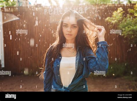 Portrait Of Beautiful Lady In Denim Shirt Dreamily Looking In Camera