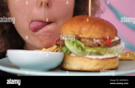 Close Up Of Hungry Girl Licks Her Lips In Front Of A Vegan Burger Stock Video Footage Alamy