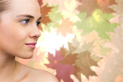 Premium Photo Smiling Blonde Natural Beauty Against Autumnal Leaf Pattern In Warm Tones