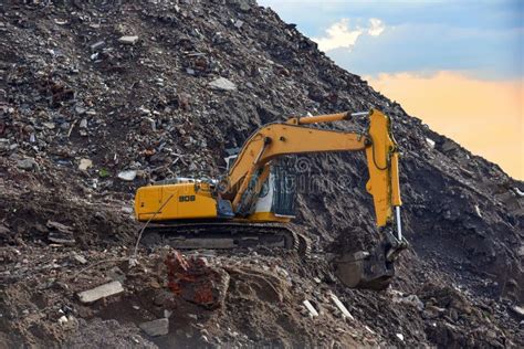 Excavator At Landfill For The Disposal Of Construction Waste Backhoe