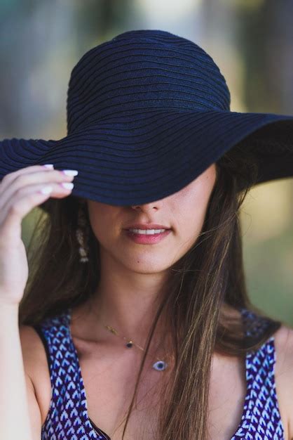 Premium Photo Portrait Of Young Woman Wearing Sun Hat