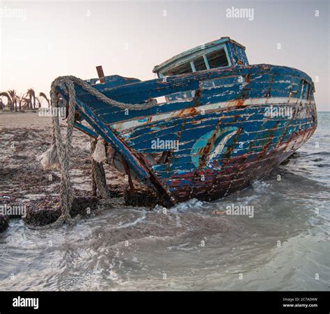 Old Wrecked Boat On The Beach With The Ropes Hanging On Stock Photo Alamy