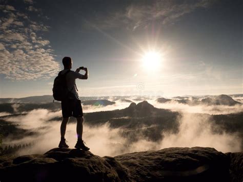 Man At The Top Of A Mountain Looking The Misty Landscape Feel Free