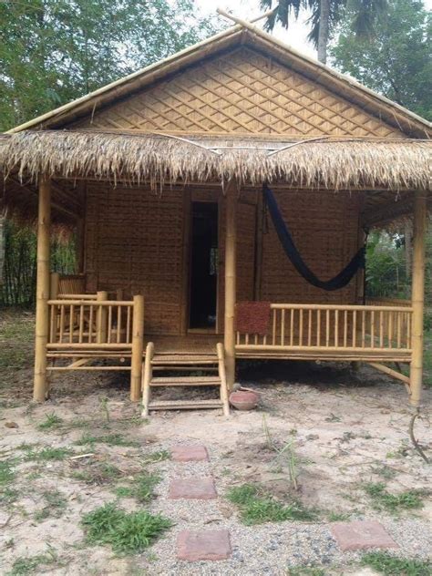 A Small Hut Made Out Of Wood And Thatched Roof With Steps Leading To