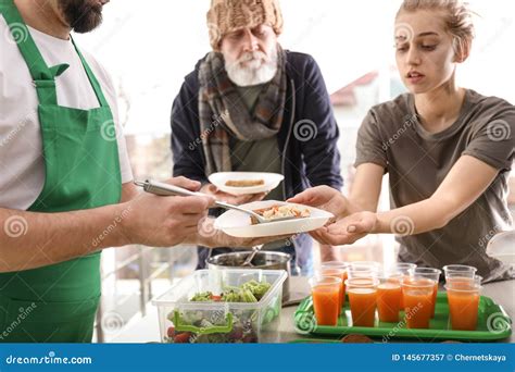 Volunteer Giving Food To People Stock Image Image Of Adult Altruism