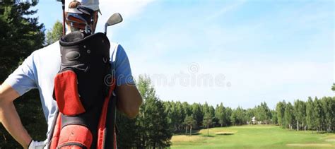 Golf Player Walking And Carrying Bag On Course During Summer Game