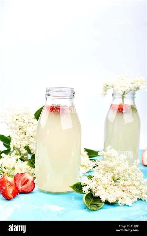 Kombucha Tea With Elderflower And Strawberry On Blue Background