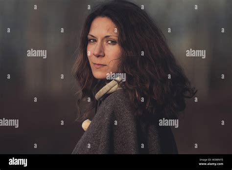 An Attractive Brunette Turns Around While Hiking Through The Woods Yukon Territory Canada