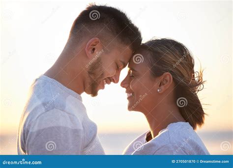 Couple Sunset Forehead Touch For Love Outdoor Beach Date And Happy