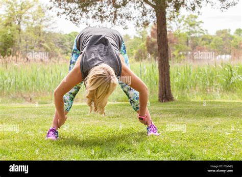 Woman in standing straddle yoga pose Stock Photo - Alamy