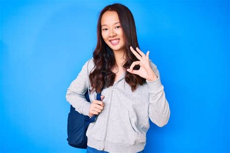 Menina Chinesa Bonita Segurando Mochila De Estudante Fazendo Sinal De