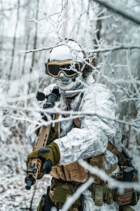 Airsoft Man In White Camouflage Uniform And Machinegun With Optical