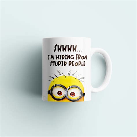 Coffee Mug With Minion Hiding From Stupid People Like We Always Do Sold