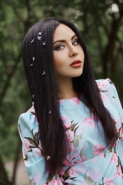 Premium Photo Brunette Woman In The Branches Of A Beautiful Flowering Tree