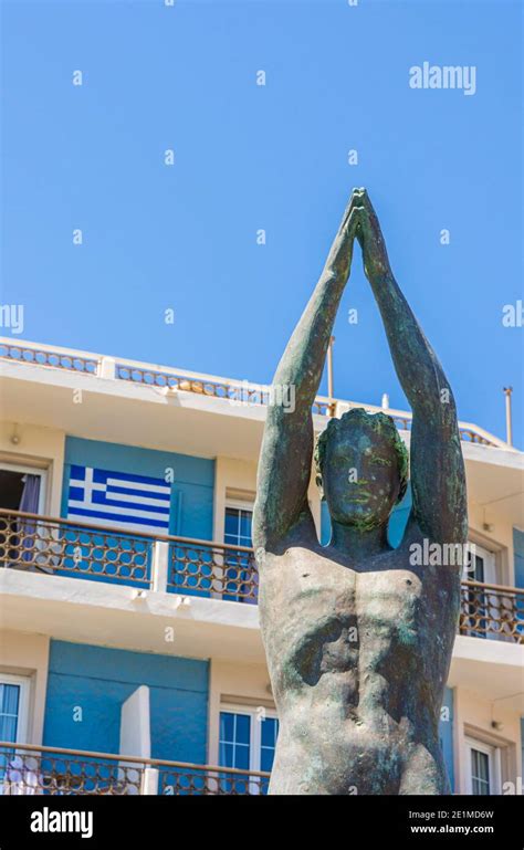 Statue Of A Naked Diver Along The Waterfront Of Pothia Town On The