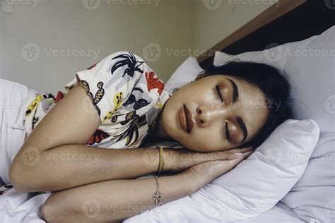 Young attractive woman sleeping in the bedroom, she is lying on the