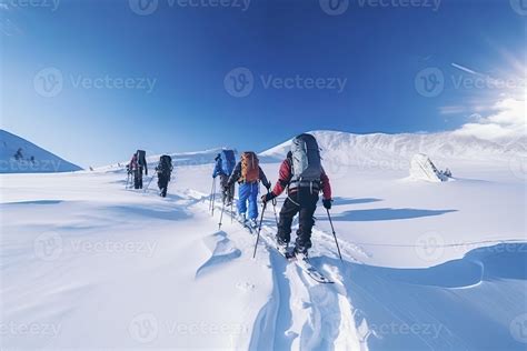 Group of mountain climbers climb the slope to the peak in sunny weather