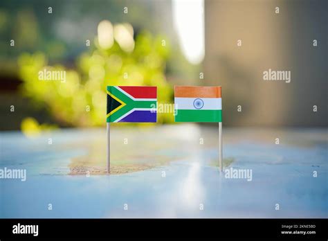 Small flags of South Africa and India on a world map representing ...