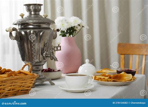 Vintage Samovar Cup Of Hot Drink And Snacks Served On Table Indoors