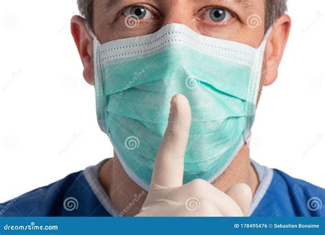 Caucasian Doctor Wearing A Protection Mask Making A Shut Up Sign On A