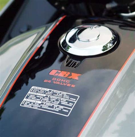 Closeup Of The Emblem On A Black And Red Motorcycle