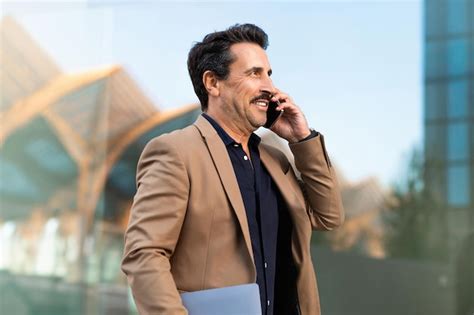 Premium Photo Portrait Of Cheerful Middle Aged Businessman Talking On