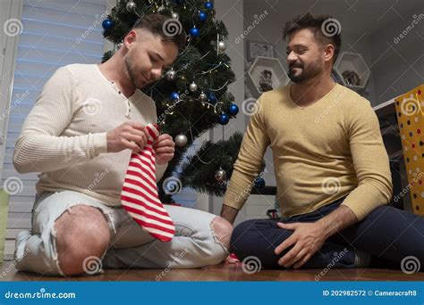 Christmas Eve Happy Gay Couple Of Men Checking Christmas Stockings For