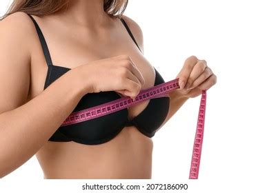 Girl Wearing Lingerie Measures Her Breast Stock Photo