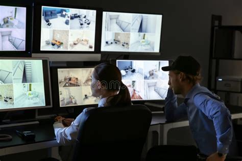 Security Guards Monitoring Modern Cctv Cameras In Surveillance Room