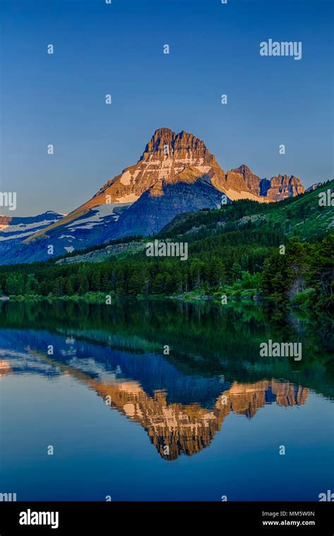 Mount Wilbur Reflected In Swiftcurrent Lake At Sunrise In Glacier