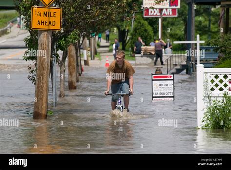 Young Man Rides Bicycle Through Flooded Streets Mohawk River Fort Plain