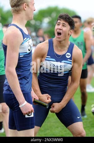 Winning The 1600 Meter Relay In A High School Track Meet Stock Photo