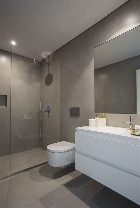 A Bathroom With A White Toilet Sitting Next To A Walk In Shower And A Sink