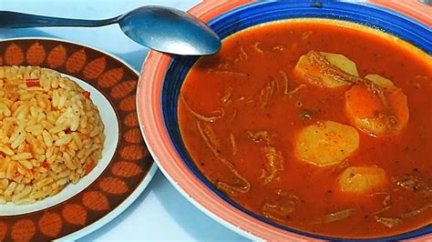 A Bowl Of Soup And Plate Of Rice On A Table