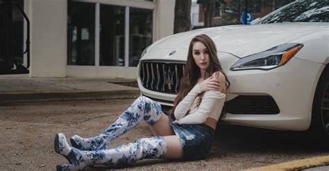 A Woman Wearing Boots Sitting on the Ground · Free Stock Photo
